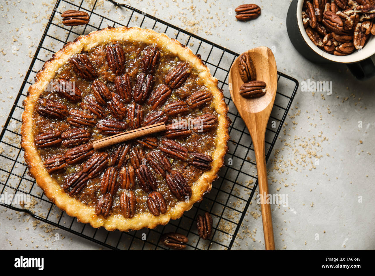 Cooling rack with tasty pecan pie on grey table Stock Photo