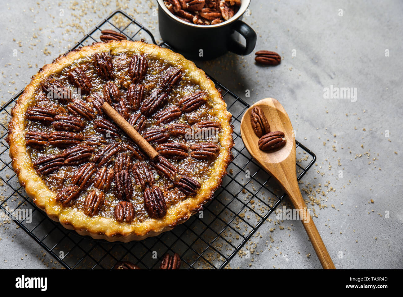 Cooling rack with tasty pecan pie on grey table Stock Photo