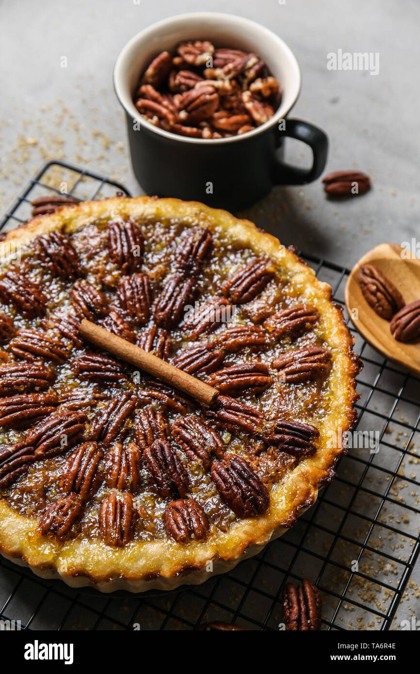 Cooling rack with tasty pecan pie on grey table Stock Photo