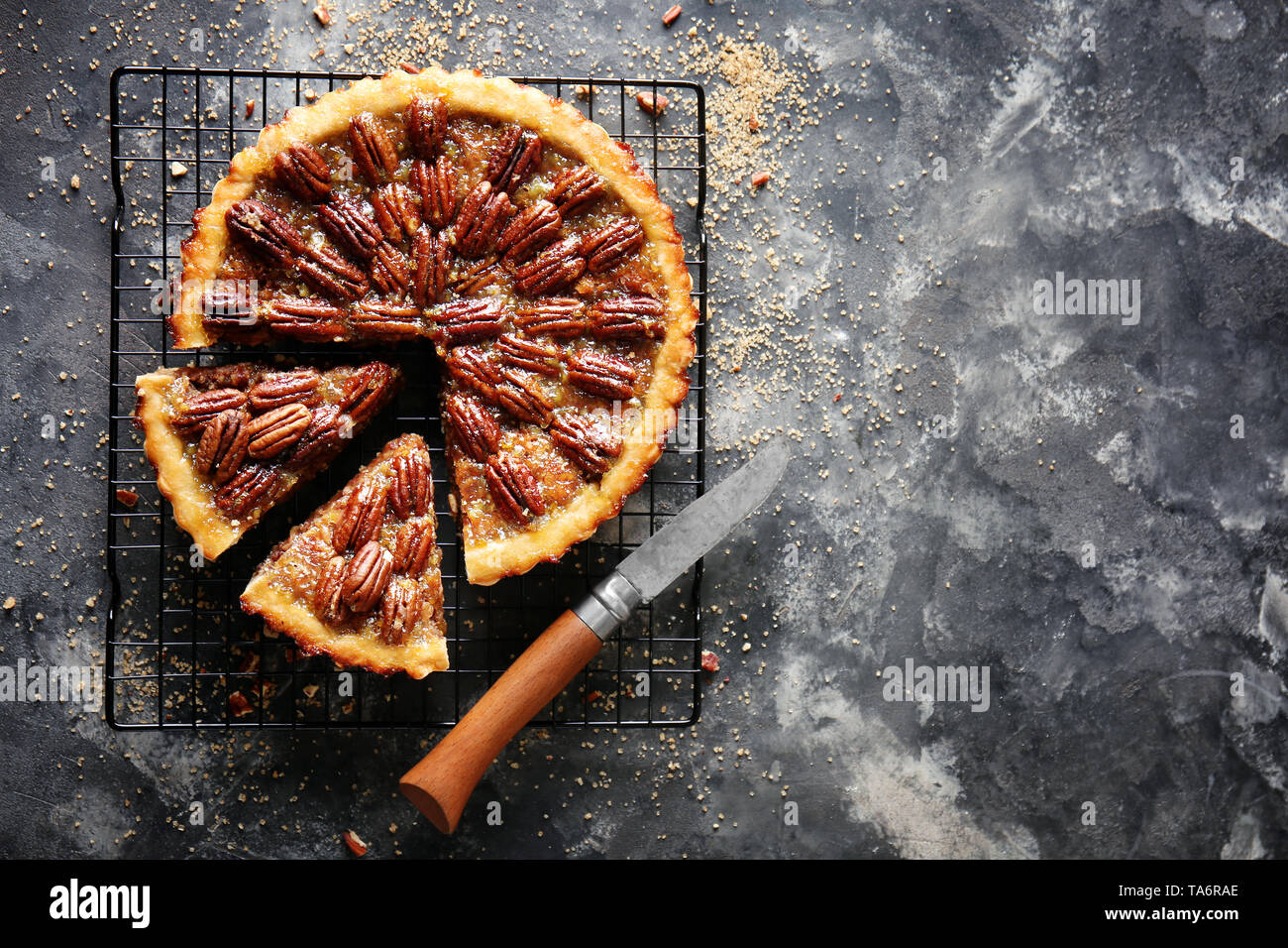 Cooling rack with tasty pecan pie on grey background Stock Photo