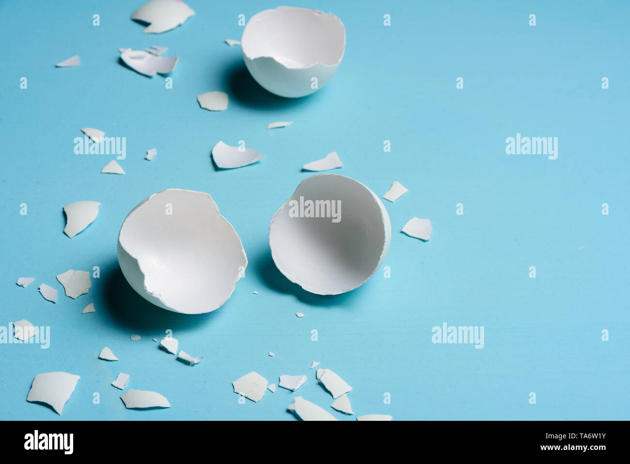 Cracked egg on light blue background. Text space Stock Photo