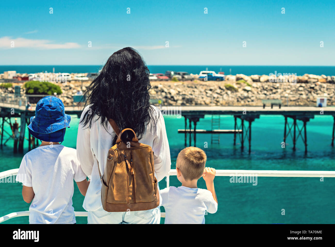 Mother with her sons standing on ferry deck while arriving at Penneshaw, Kangaroo Island Stock Photo