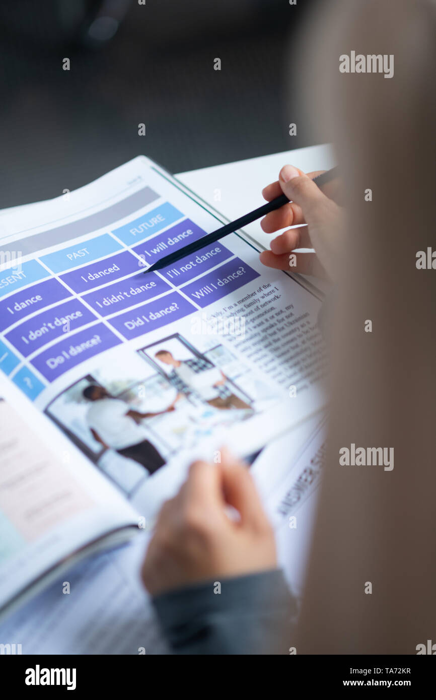 Young English teacher reading book before lesson Stock Photo - Alamy