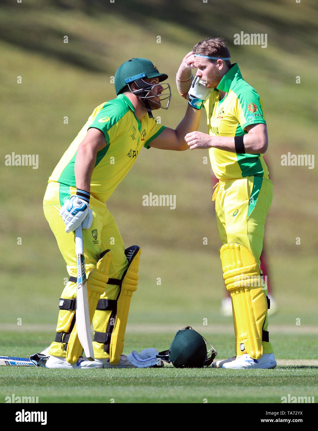 Australia's Aaron Finch (left) helps team mate Steve Smith check his eye during the World Cup warm-up match at the Nursery Ground, Southampton. Stock Photo