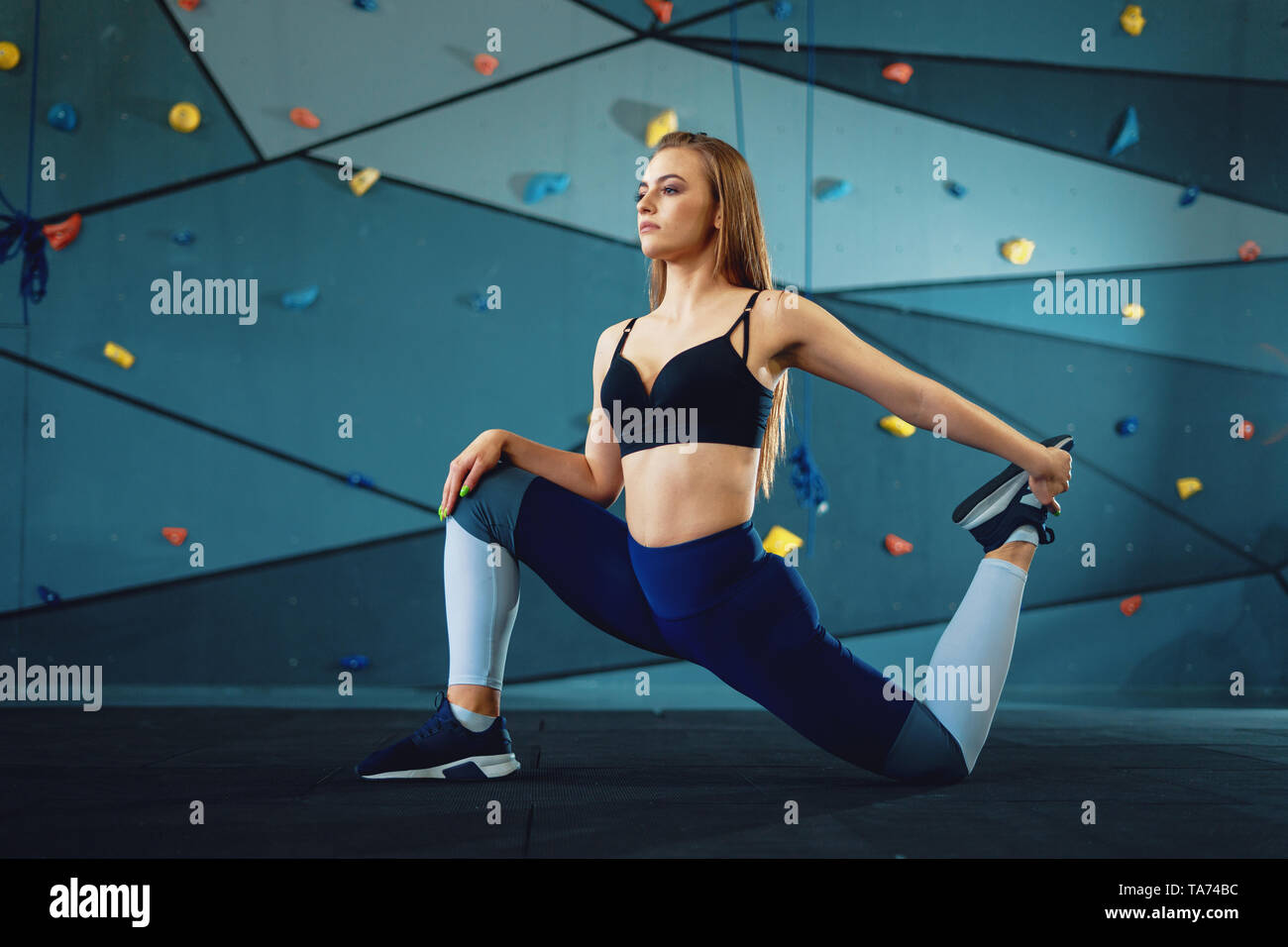 Beautiful athletic woman gymnast in sportswear performs gymnastics fitness  exercises on a gray background. Sports motivation, stretching. - Stock  Image - Everypixel