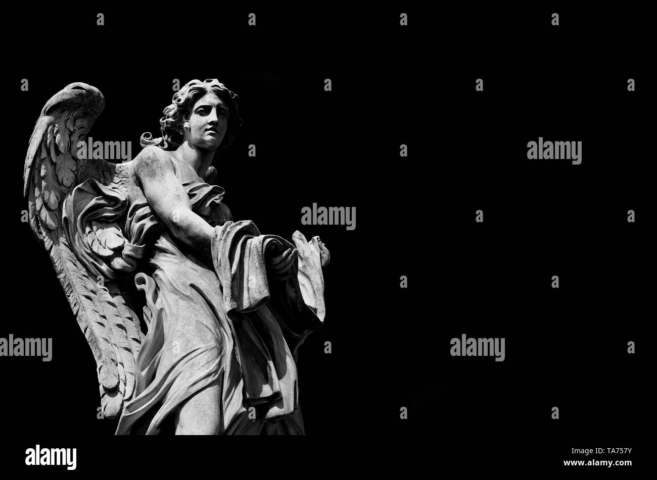 Angel marble statue with garment and dice, a 17th century baroque masterpiece on Holy Angel Bridge in Rome (Black and White with copy space) Stock Photo