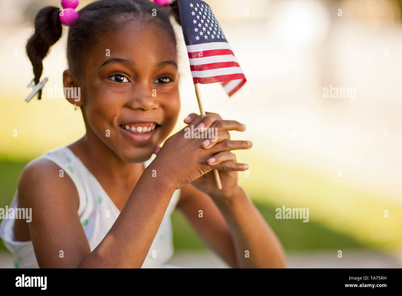 Young girl holding an American flag Stock Photo - Alamy