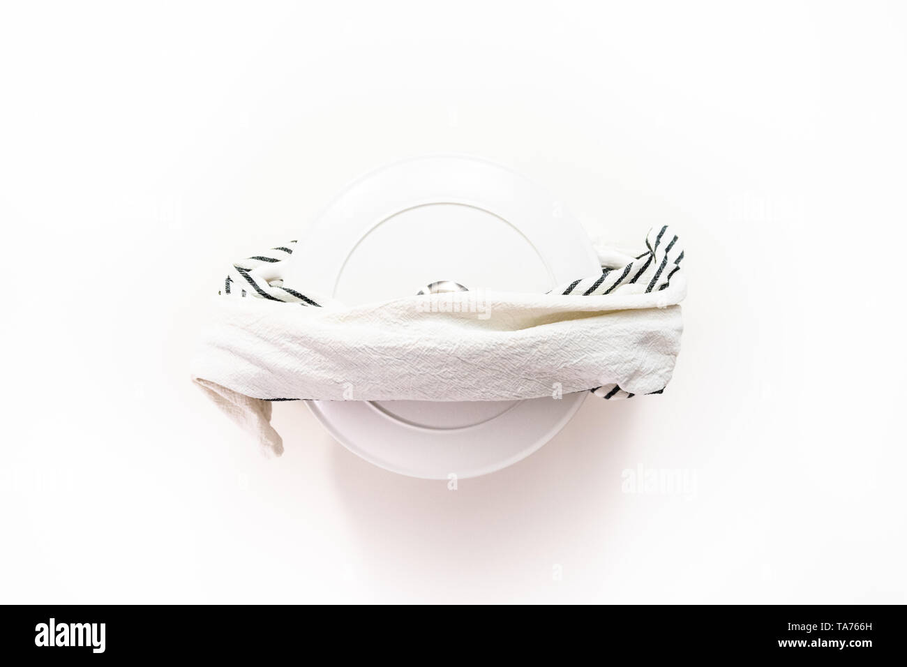 Flat lay. White enameled cast iron covered round dutch oven on a whjite background. Stock Photo