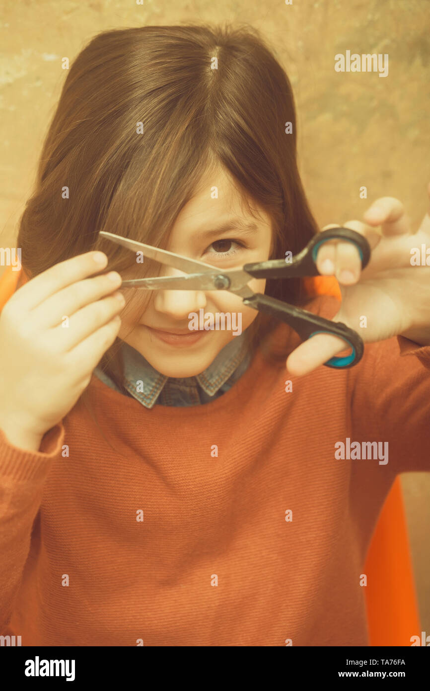 Pretty girl cutting hair with scissors Stock Photo Alamy