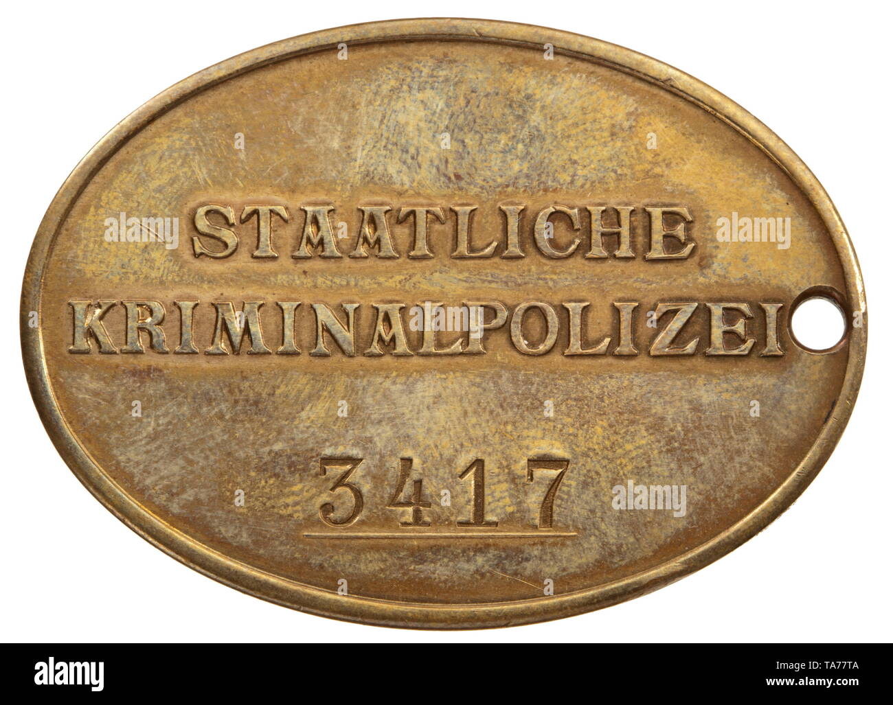 An identification badge of the national criminal police Bronze and  non-ferrous metal, with national eagle embossed on the front. The reverse  with embossed inscription "STAATLICHE KRIMINALPOLIZEI" (tr. "national  criminal police") and struck