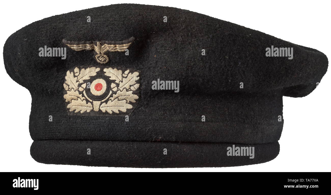 A protective Panzer beret complete with removable cover Padded body with black felt finishing coat, six large rubber ventilation rivets, six-section black oil cloth liner with brown leather sweatband. Supply stamping. Black knitted cover in the shape of a beret with late, grey-woven emblems on a black base. Size 57. historic, historical, army, armies, armed forces, military, militaria, object, objects, stills, clipping, clippings, cut out, cut-out, cut-outs, 20th century, Editorial-Use-Only Stock Photo