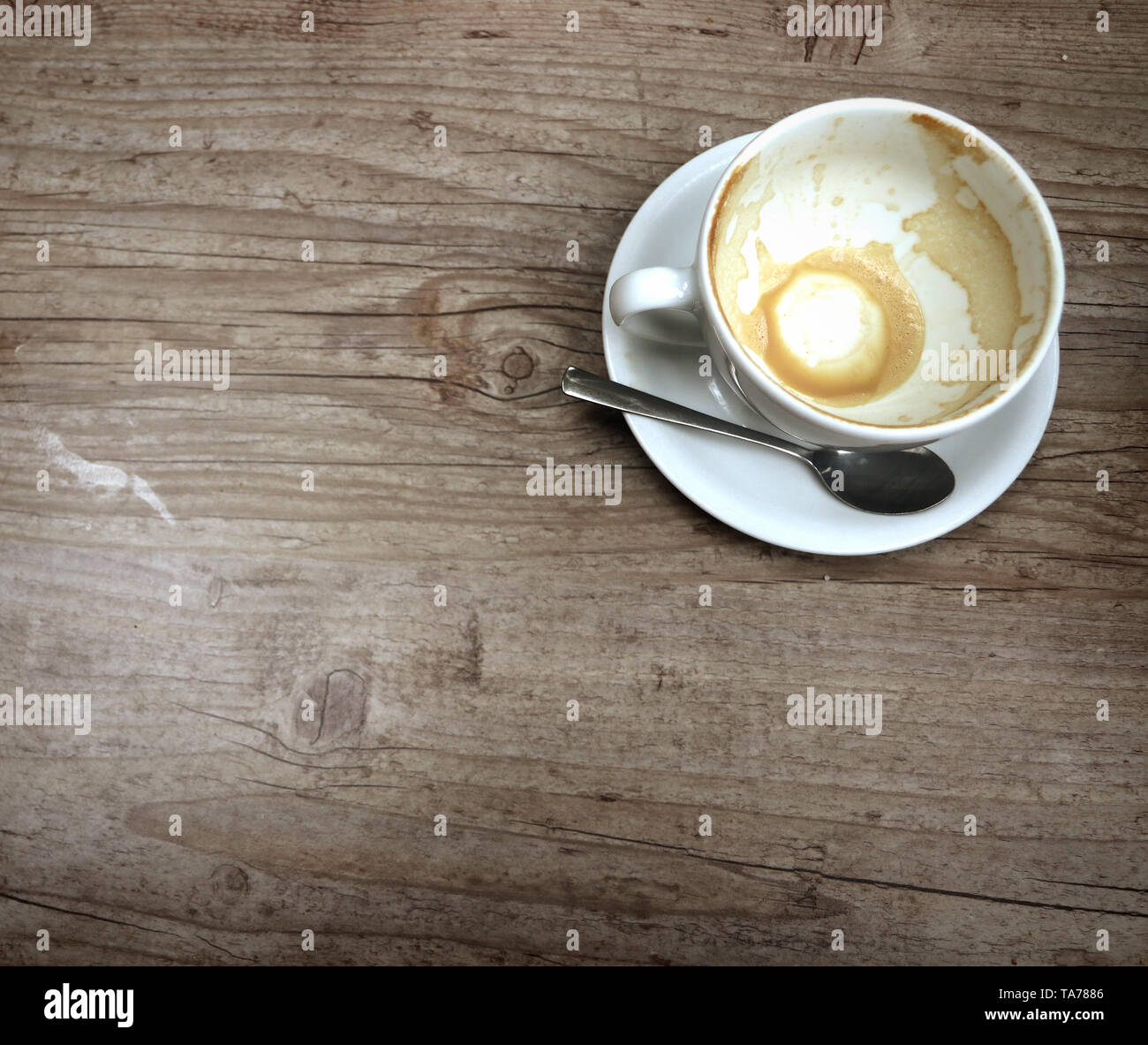 Empty capuccino cup on a grunge wooden board Stock Photo