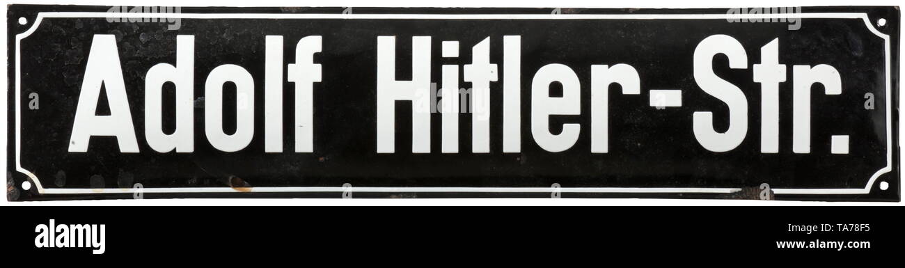 An enamel sign 'Adolf Hitler-Str.' Gewölbtes Eisenschild, schwarz emailliert und mit weißer Schrift. Emailleabsplitterungen am Rand. Maße 15 x 68,5 cm. historic, historical, State, state-controled, state-run, organisations, organizations, organization, organisation, object, objects, stills, clipping, clippings, cut out, cut-out, cut-outs, utensil, piece of equipment, utensils, 20th century, Additional-Rights-Clearance-Info-Not-Available Stock Photo