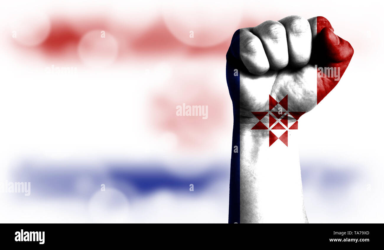 Flag of Mordovia painted on male fist, strength,power,concept of conflict. On a blurred background with a good place for your text. Stock Photo