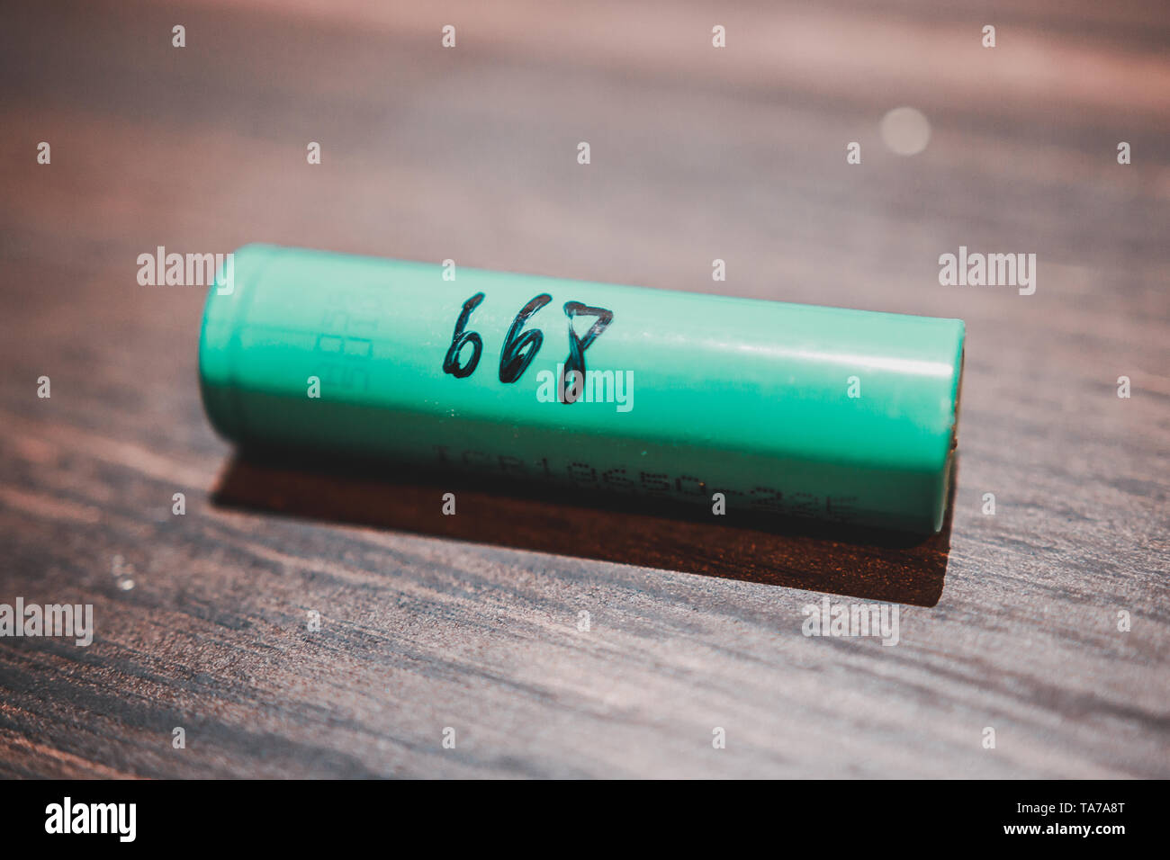 One 18650 Lithium Ion Battery cell on a wooden table known for use with vape  or e cigarette. Also used to make laptop battery and power bank Stock Photo  - Alamy