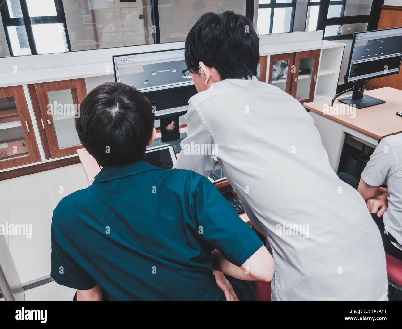 Thai Computer Engineering students working on a programming project in ...