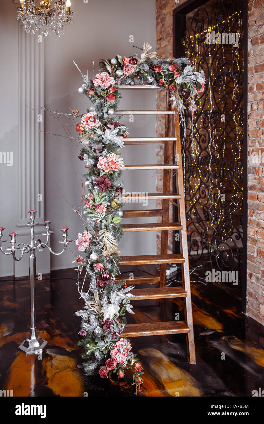 Wooden staircase decorated with glowing garland and Christmas toys Stock Photo