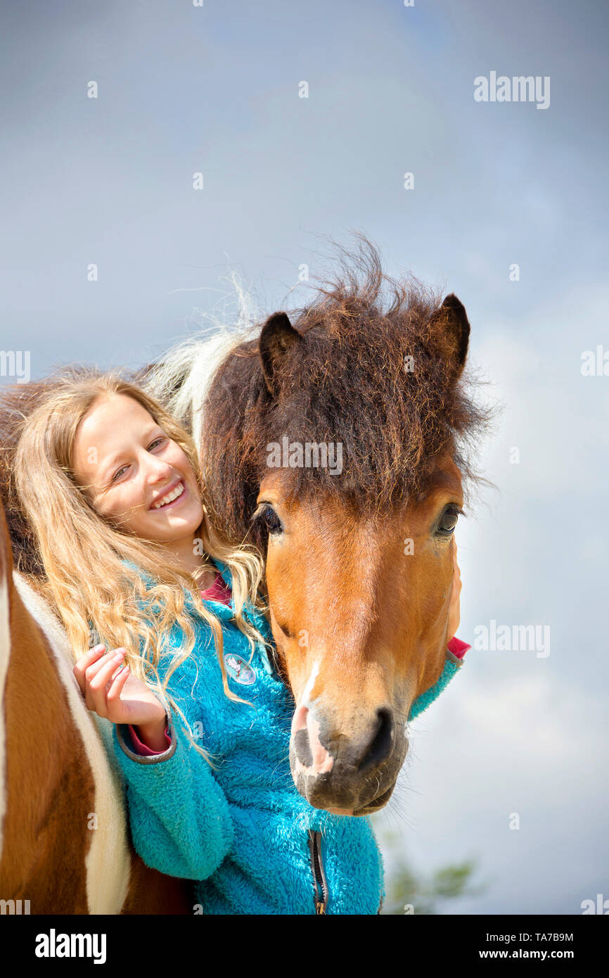 Icelandic Horse. Girl smooching with pinto horse. Austria Stock Photo