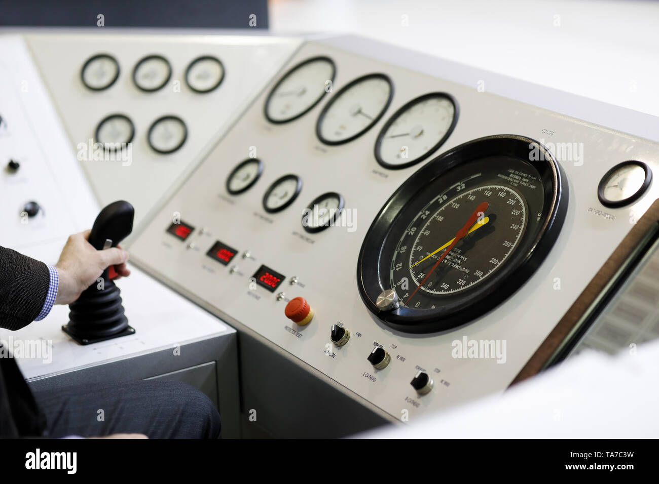 An engineer working at the remote control console of petroleum drilling rig. Selective focus. Stock Photo