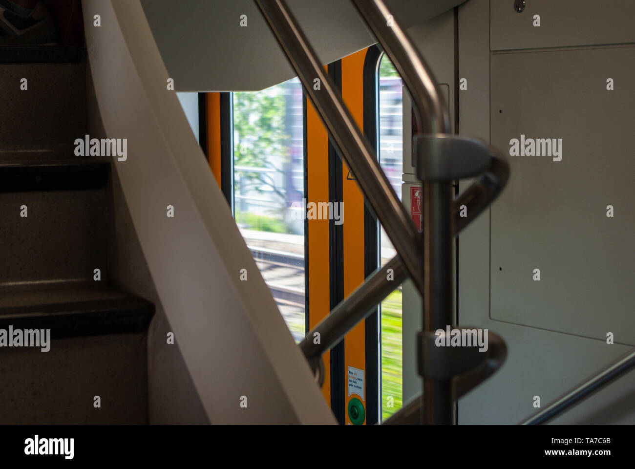 handrail and stairway inside a ODEG Regionalexpress RE2 - Lübbenau, Brandenburg/Germany - May 19th 2019 Stock Photo