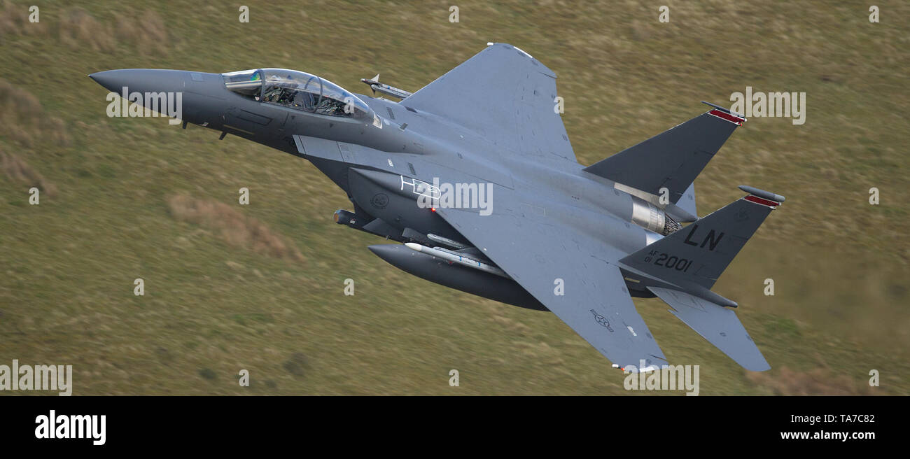 USAF F-15E Strike Eagle flying low level through the Mach Loop in Wales, UK Stock Photo