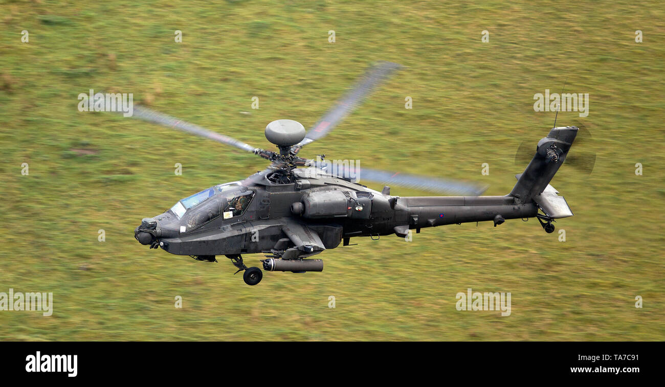 Army Air Corps WAH-64 Apache flying low level in the Mach Loop in Wales, UK Stock Photo