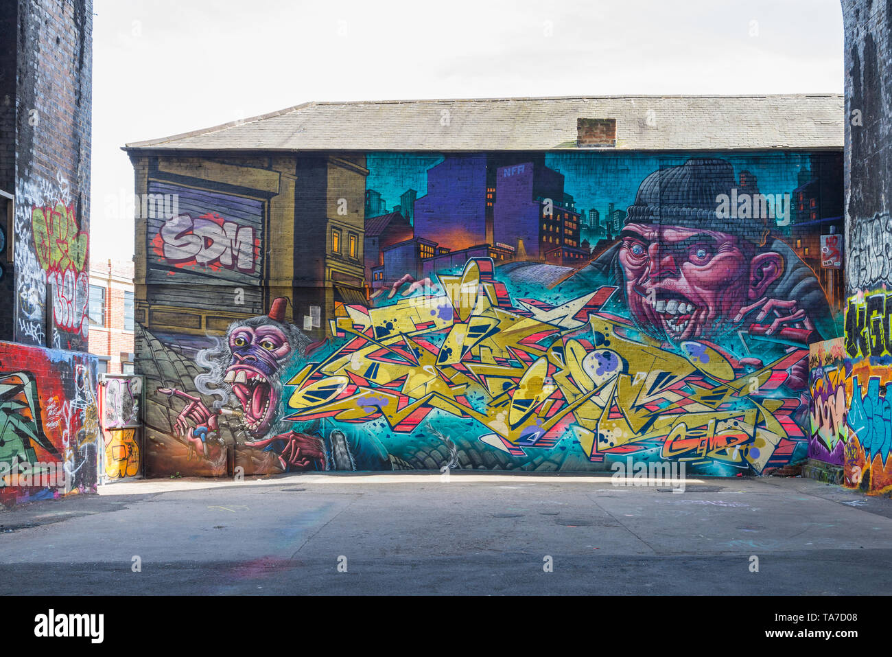 Colourful street art decorating a brick wall in Digbeth, Birmingham's