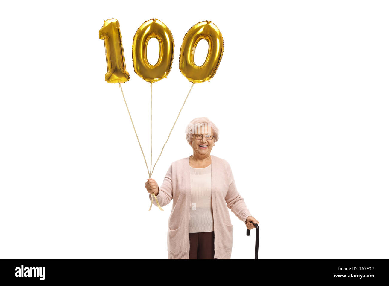 Old woman with a golden number hundred balloon and a walking cane isolated on white background Stock Photo
