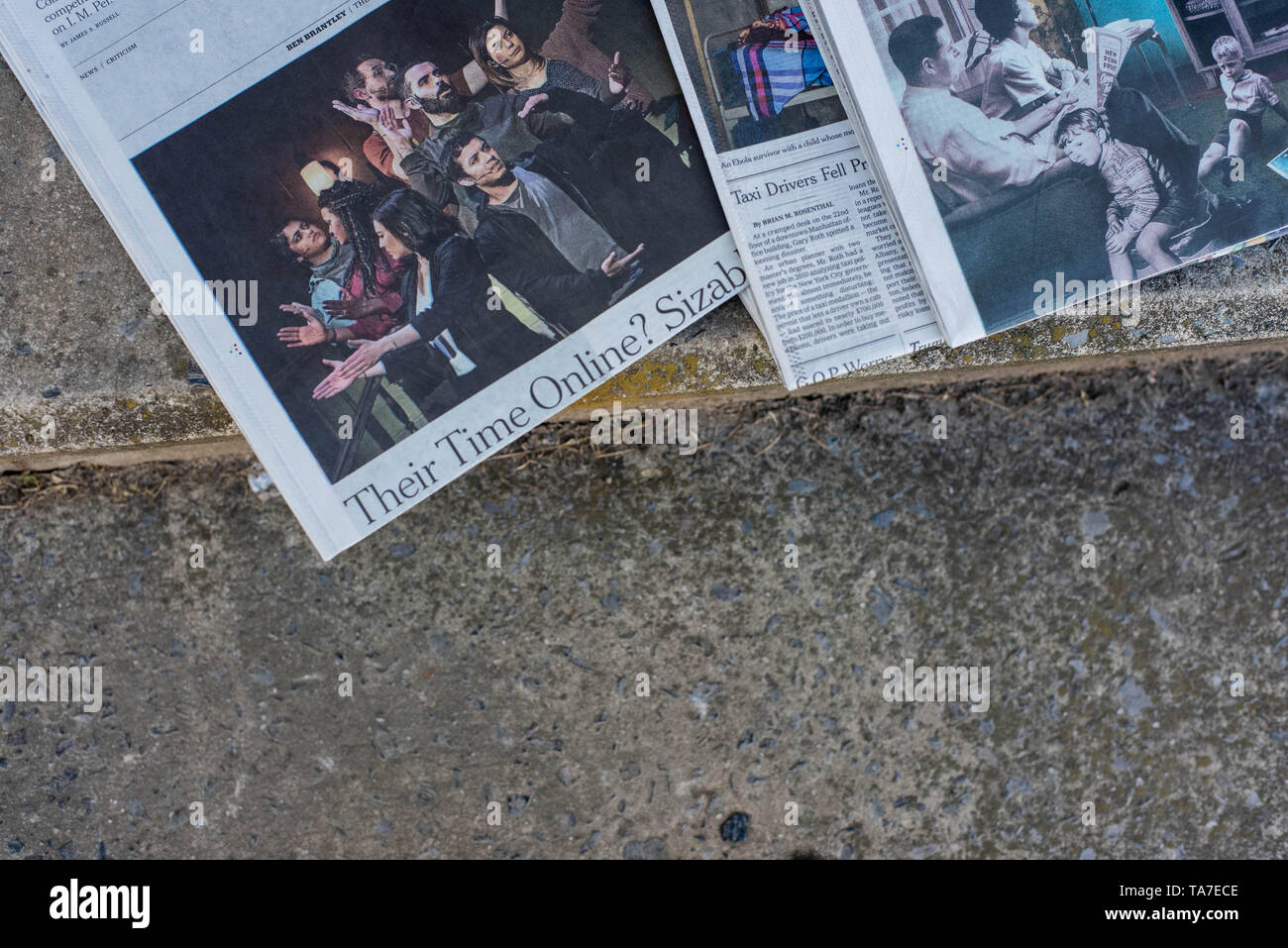 A stack of newspapers, The New York Times and USA Today, lay on a table. Stock Photo