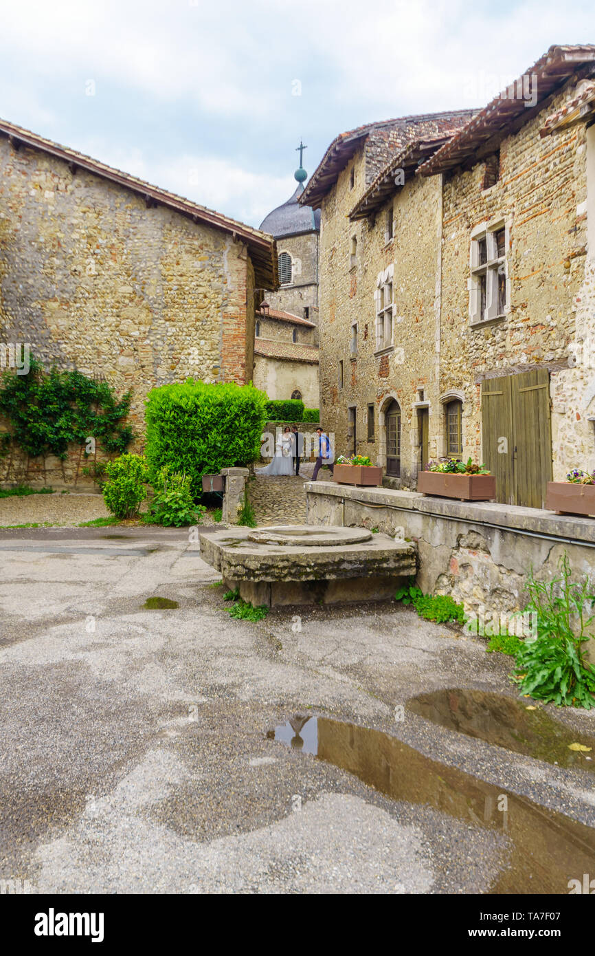 Perouges, France - May 04, 2019: Alley scene, with bride, groom and ...