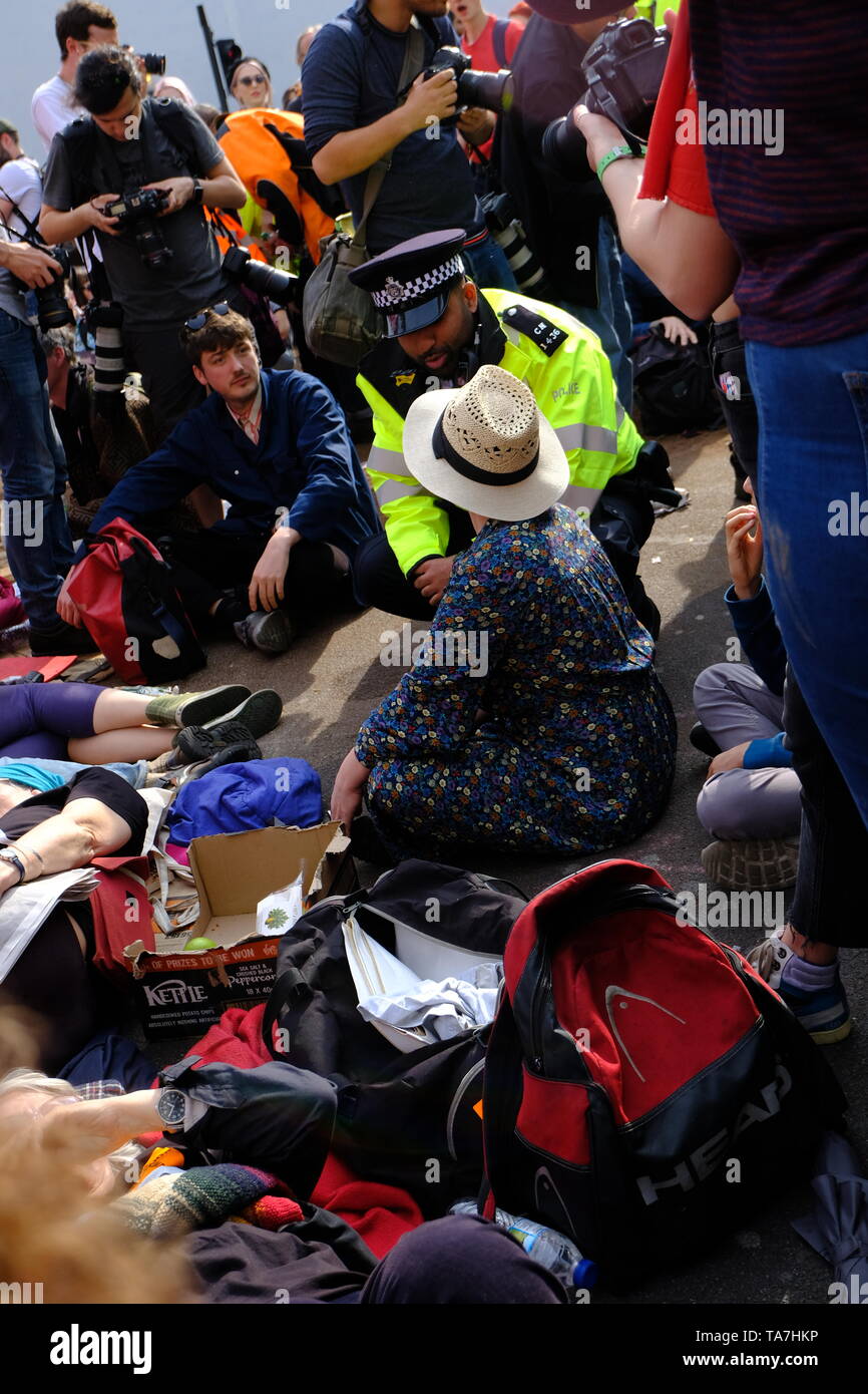 Extinction Rebellion protester (a mother with son) prepares for arrest on the fourth day of official protest. Stock Photo