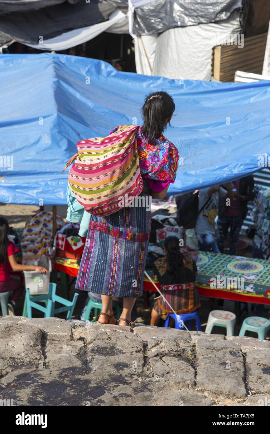 Ethnic Guatemalan Woman with shoulder bag carrying merchandise for sale walking on Thursday Market Day in Town of Chichicastenango, Guatemala Stock Photo