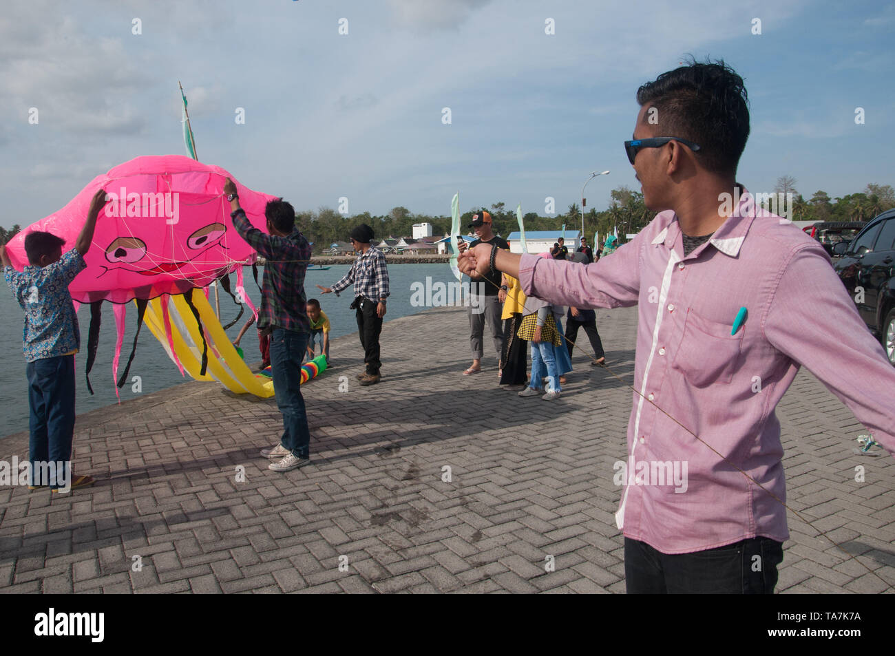 Bulukumba, Indonesia - September 13, 2018: Men try to fly a kite during International Pinisi Festival in Bulukumba, South Sulawesi, Indonesia. Stock Photo