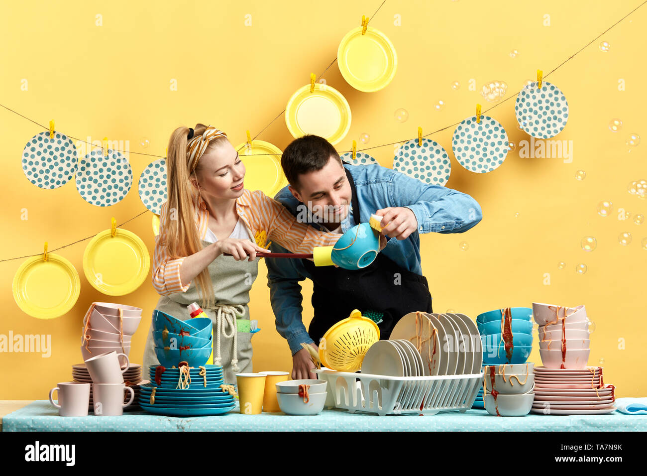 curious man and woman looking for sports, dust in the kitchenwear in the kitchen with yellow wall. close up photo Stock Photo