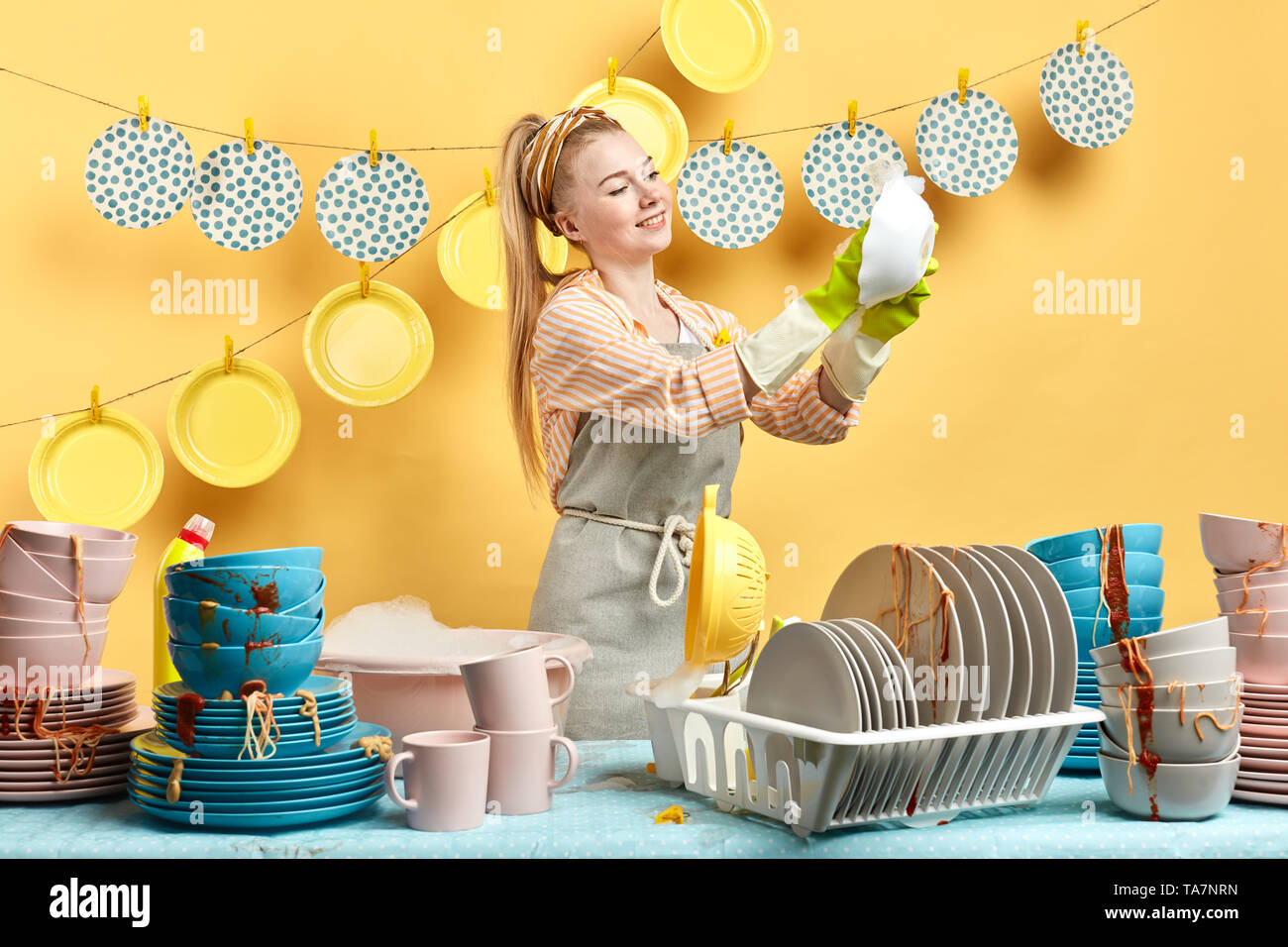 young good looking housewife doing the dishes. close up side view photo.  interest, part time job. close up photo Stock Photo - Alamy