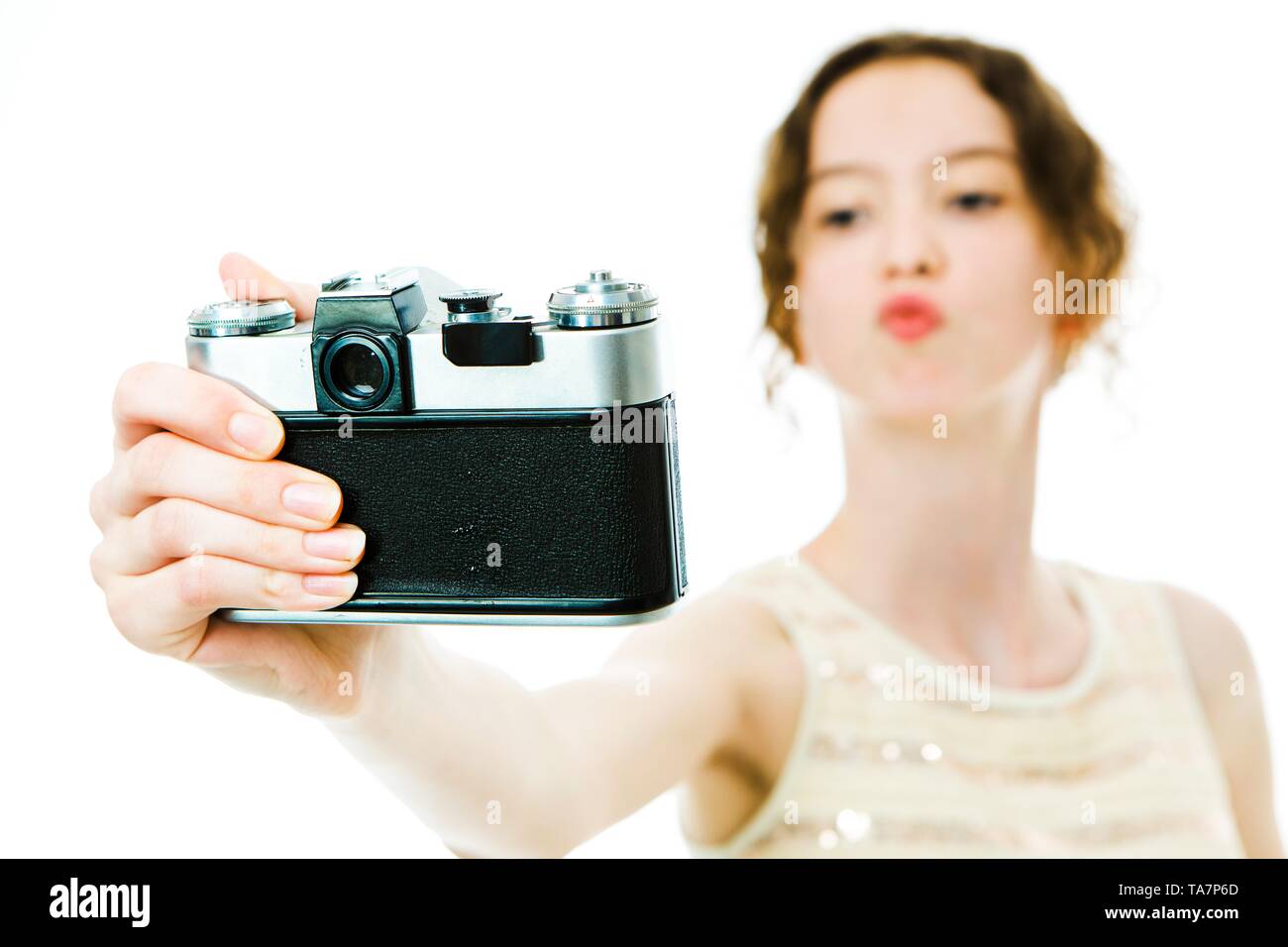 Young Slim Girl Taking Selfie With Vintage Analog Camera Showing Kiss