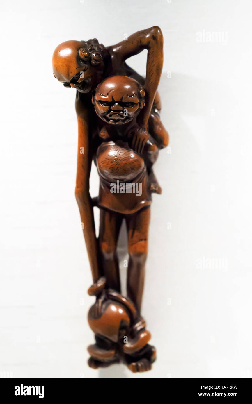 Long-armed, long-legged figures with octopus Netsuke figurine Stock Photo