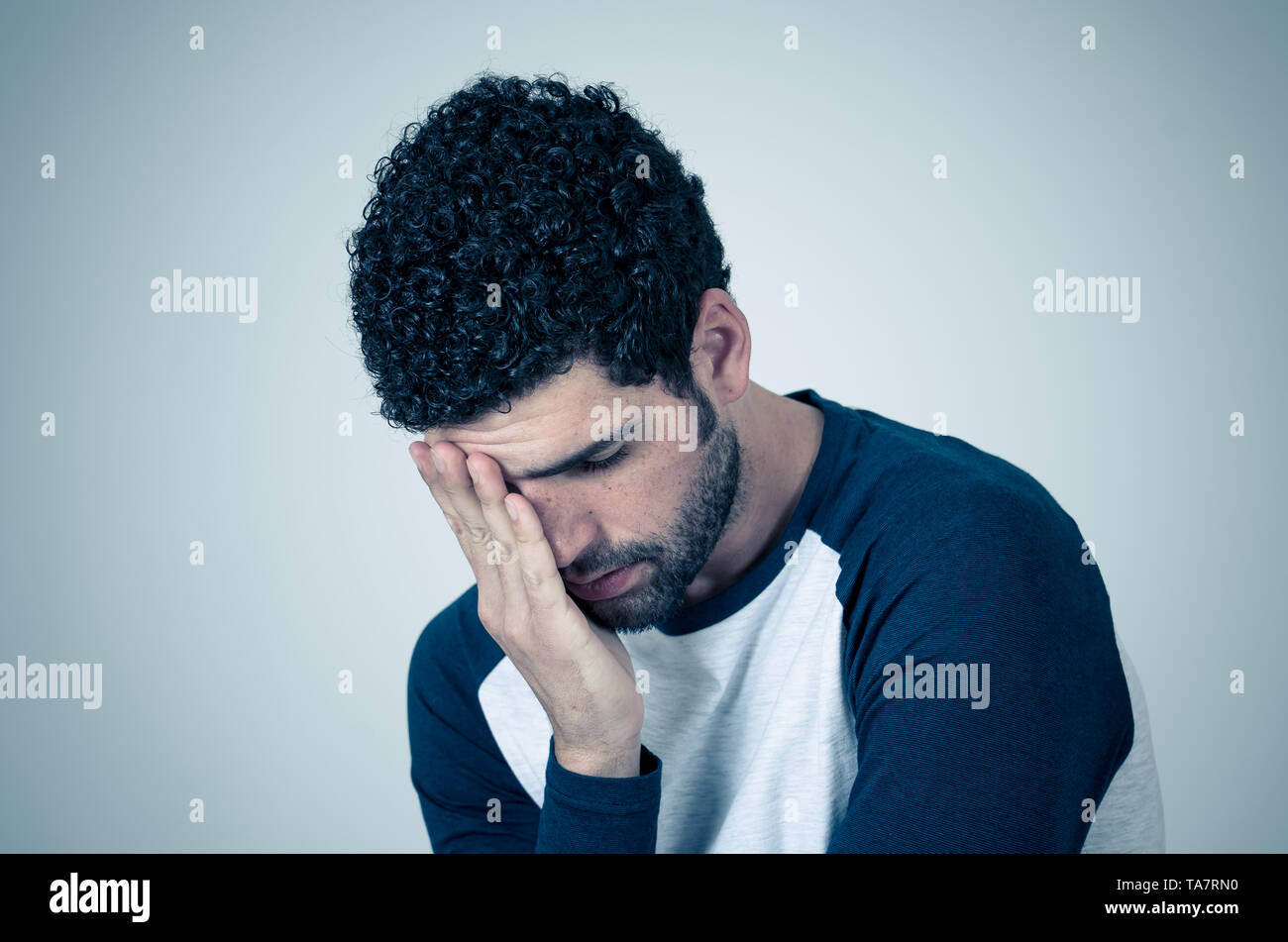 Young sad man, worried and concerned, looking depressed and desperate feeling sorrow. Portrait with copy space. In People, facial expressions and emot Stock Photo