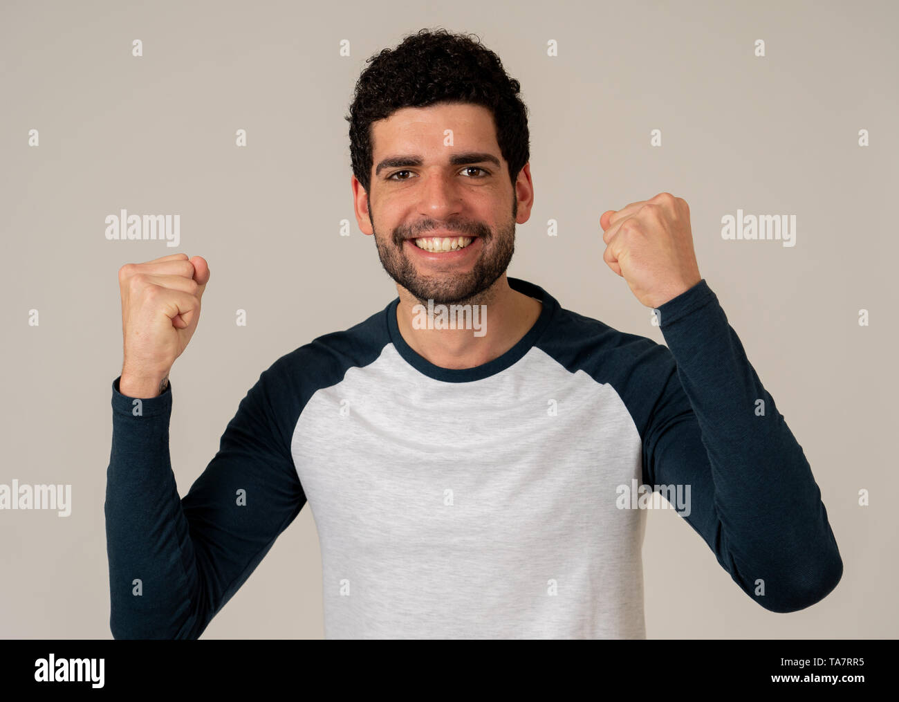 Portrait of young happy and excited man winning the lottery celebrating goal or having great success with proud face. In People success and Facial Exp Stock Photo