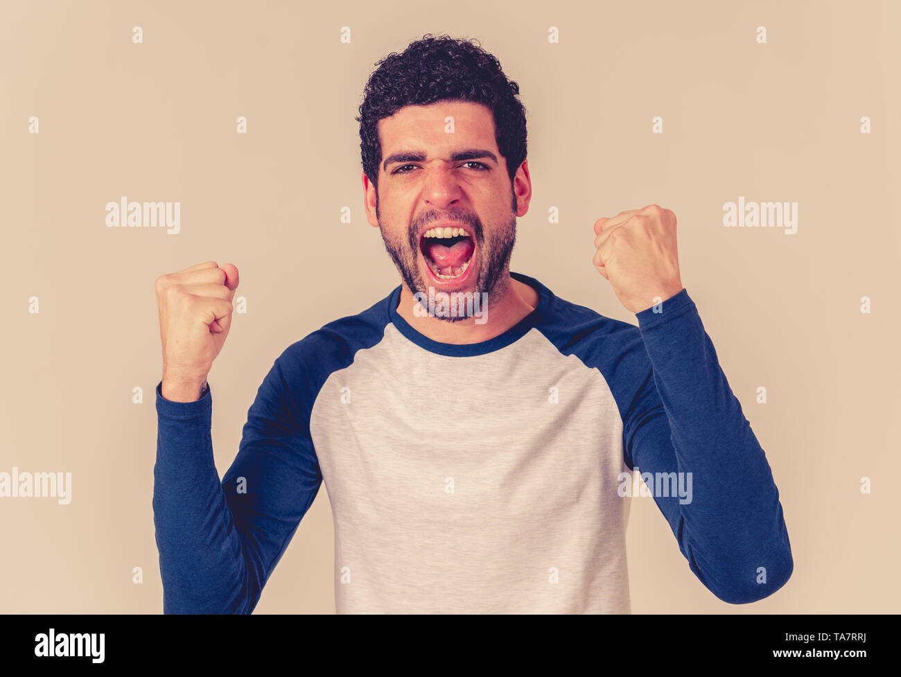 Portrait of young happy and excited man winning the lottery celebrating goal or having great success with proud face. In People success and Facial Exp Stock Photo