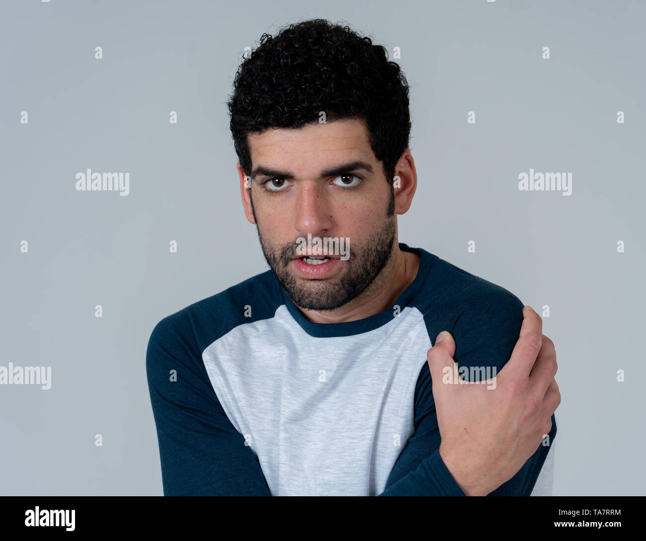 Portrait of young man in shock with scared face with frightened gestures and looking at something scaring. Human emotions feelings and facial expressi Stock Photo