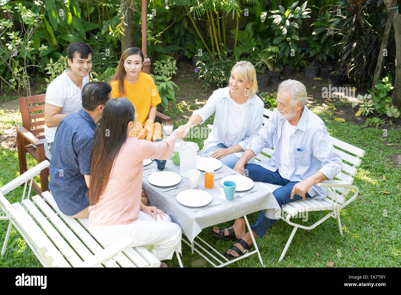 The happiness of two ethnic families - Image Stock Photo