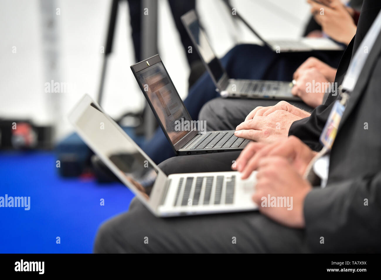 Detail with journalists hands typing on laptops during a press conference Stock Photo