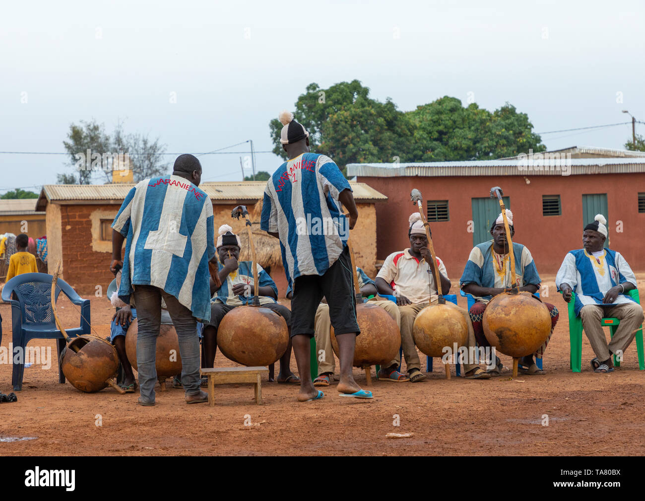 African musicians playing koras during Boloye dance of the panther man, Savanes district, Waraniene, Ivory Coast Stock Photo