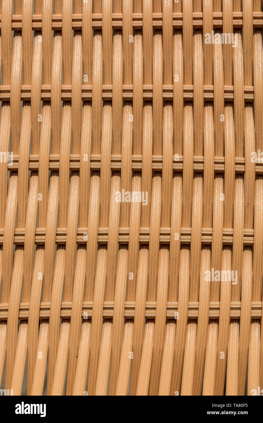 Beige wattled structures of garden chairs for background Stock Photo