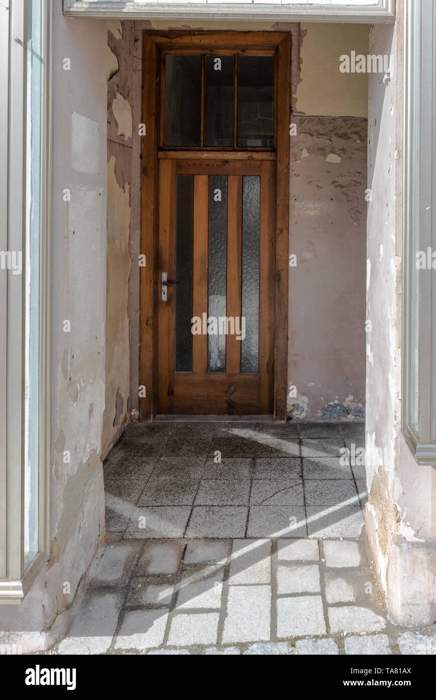 Smashed Wall Entry Old broken entrance area of a front door with glass walls and glass ...