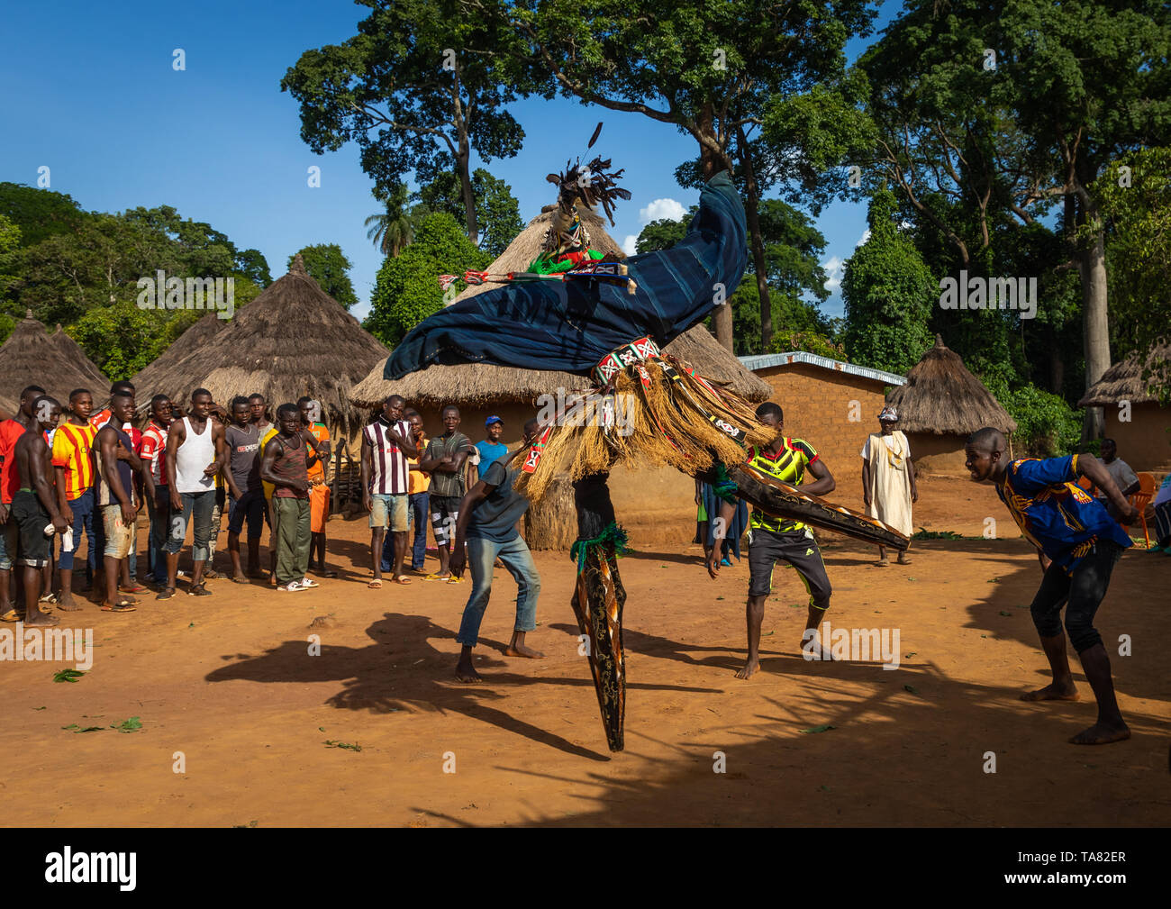 The tall mask dance with stilts called Kwuya Gblen-Gbe in the Dan tribe during a ceremony, Bafing, Gboni, Ivory Coast Stock Photo