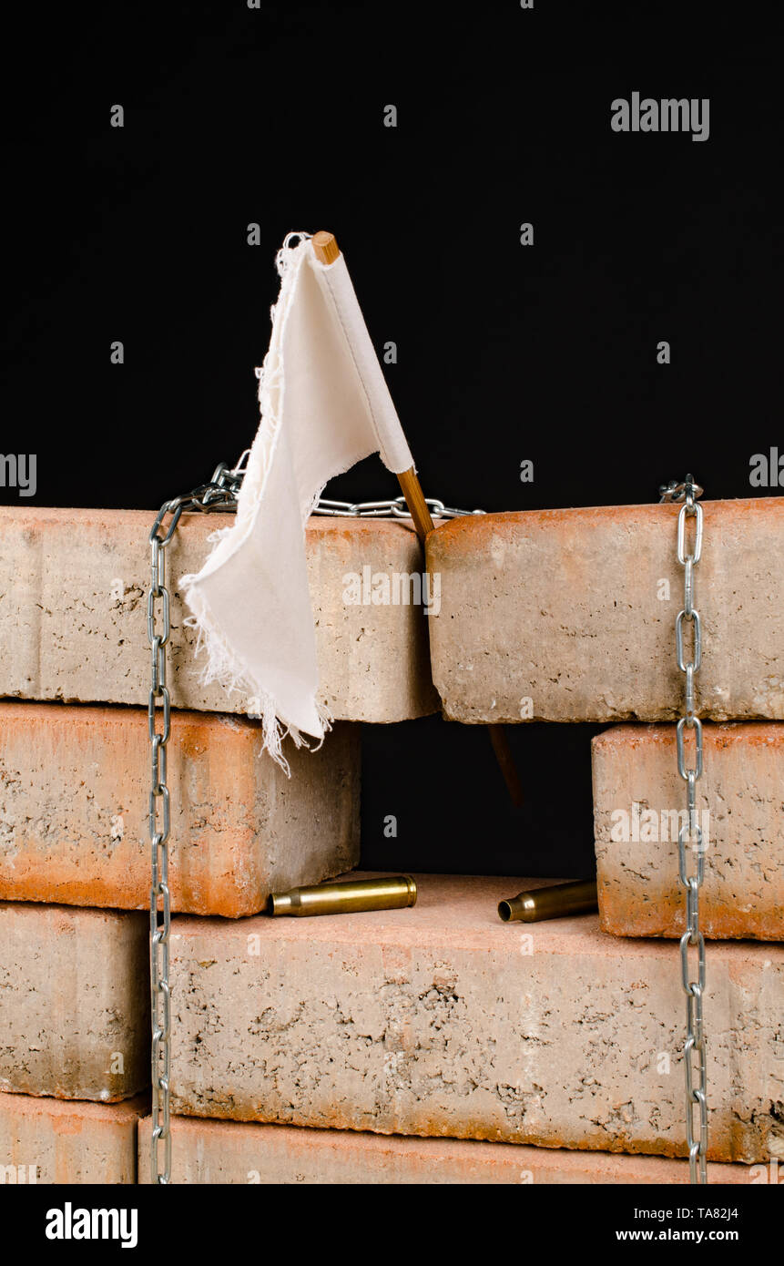 White flag over the wall, a concept on immigration and wars Stock Photo