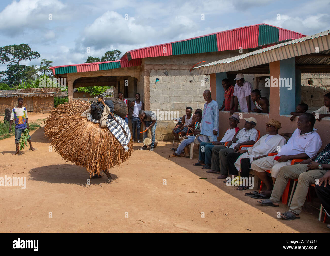 We Guere sacred mask dance in front of the village leaders during a ceremony, Guémon, Bangolo, Ivory Coast Stock Photo