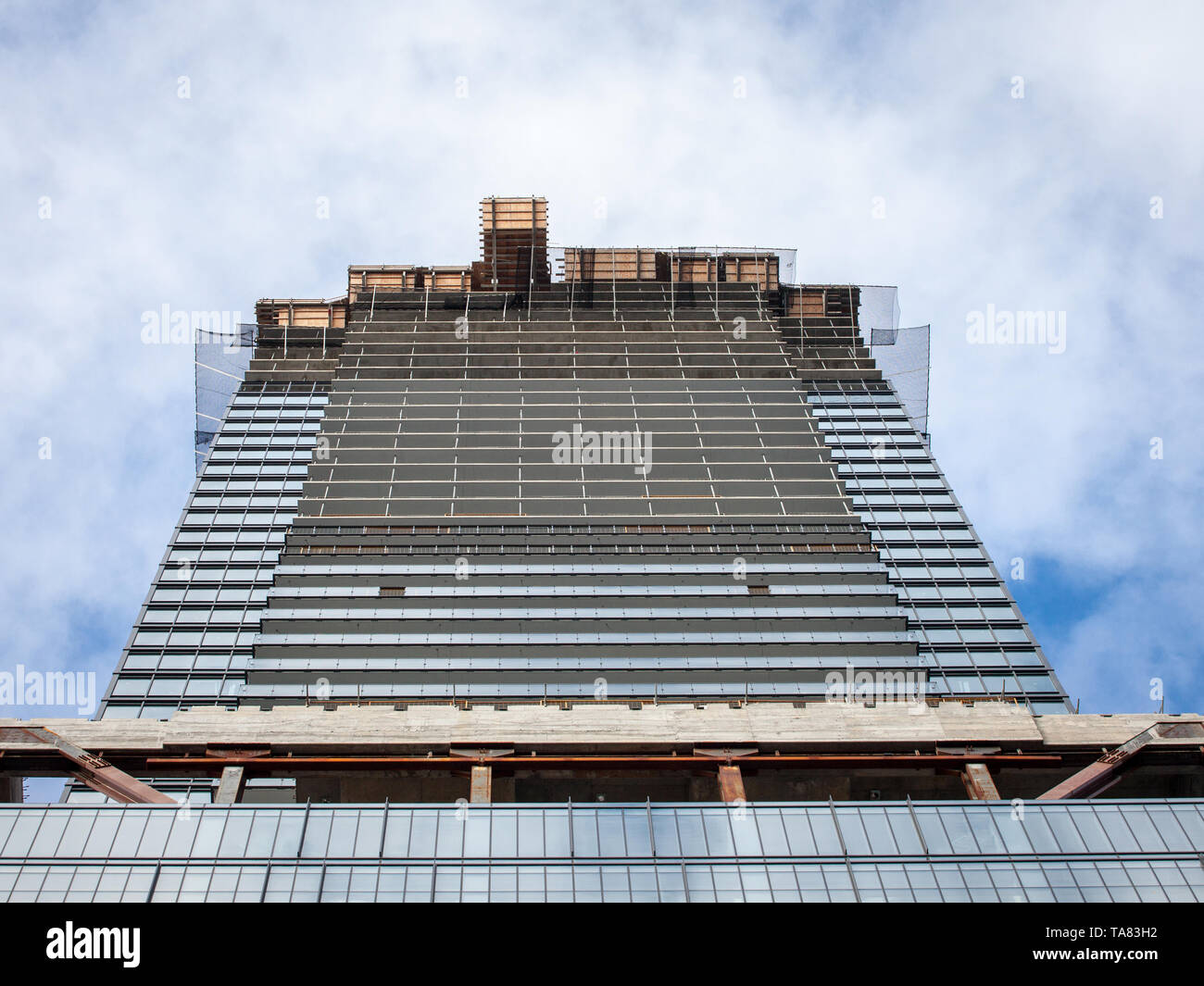 Cranes and building devices on a construction site of a skyscraper in downtown Toronto, surrounded by other high rise towers and condos as well as old Stock Photo